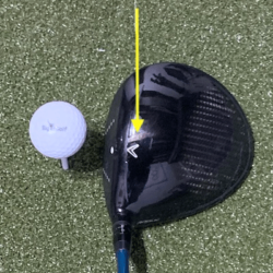 Driver setup to a golf ball, with arrow directing where to look.