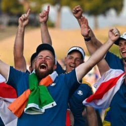 Europe Ryder Cup team celebrating with their flags and trophy.